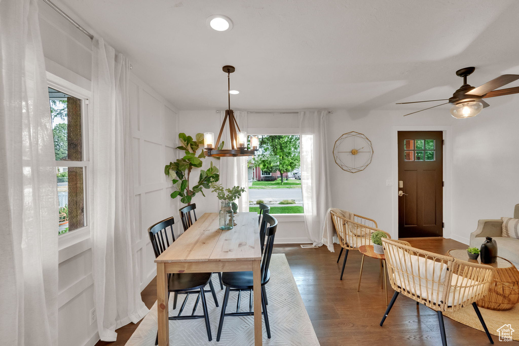 Dining area with healthy amount of natural light, dark wood-style floors, a chandelier, and recessed lighting