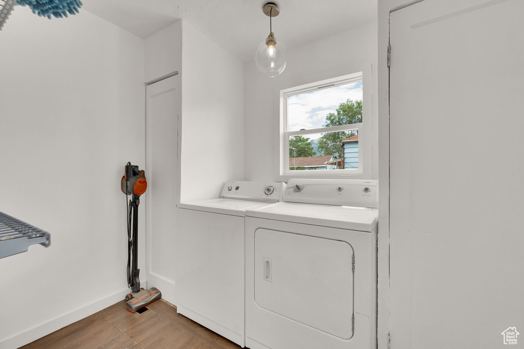 Washroom featuring washing machine and dryer and baseboards