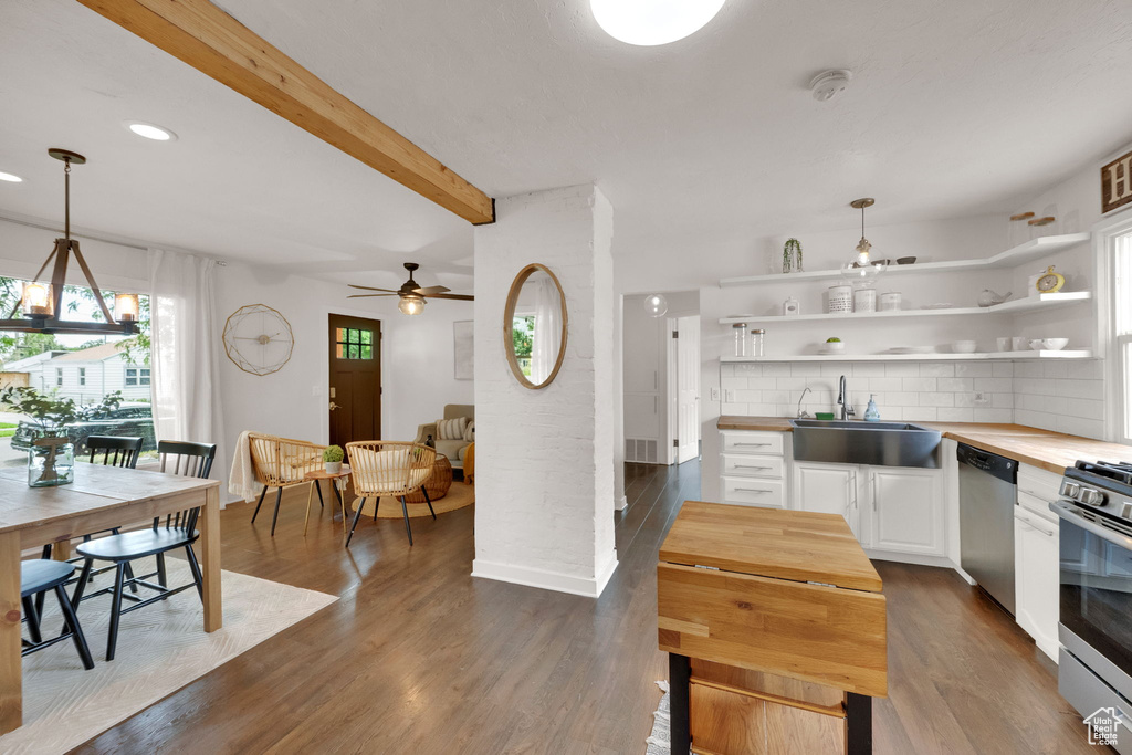 Kitchen featuring wooden counters, appliances with stainless steel finishes, a ceiling fan, open shelves, and white cabinets