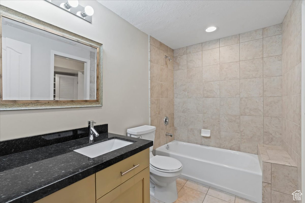 Bathroom with vanity, washtub / shower combination, tile patterned flooring, a textured ceiling, and recessed lighting