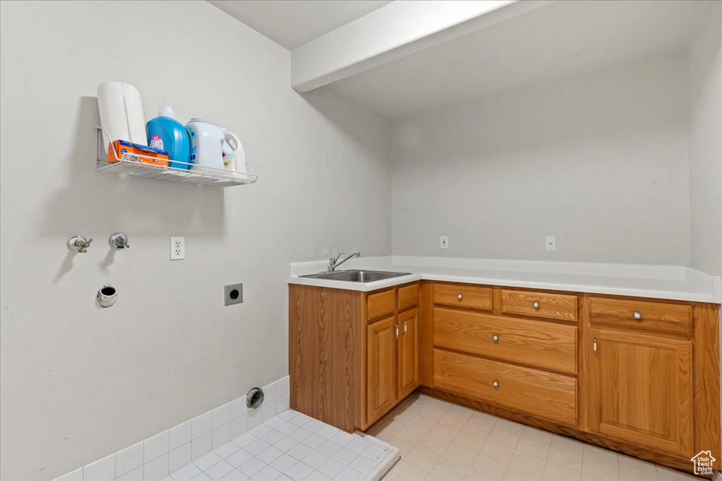 Laundry room with hookup for an electric dryer, washer hookup, and light tile patterned floors