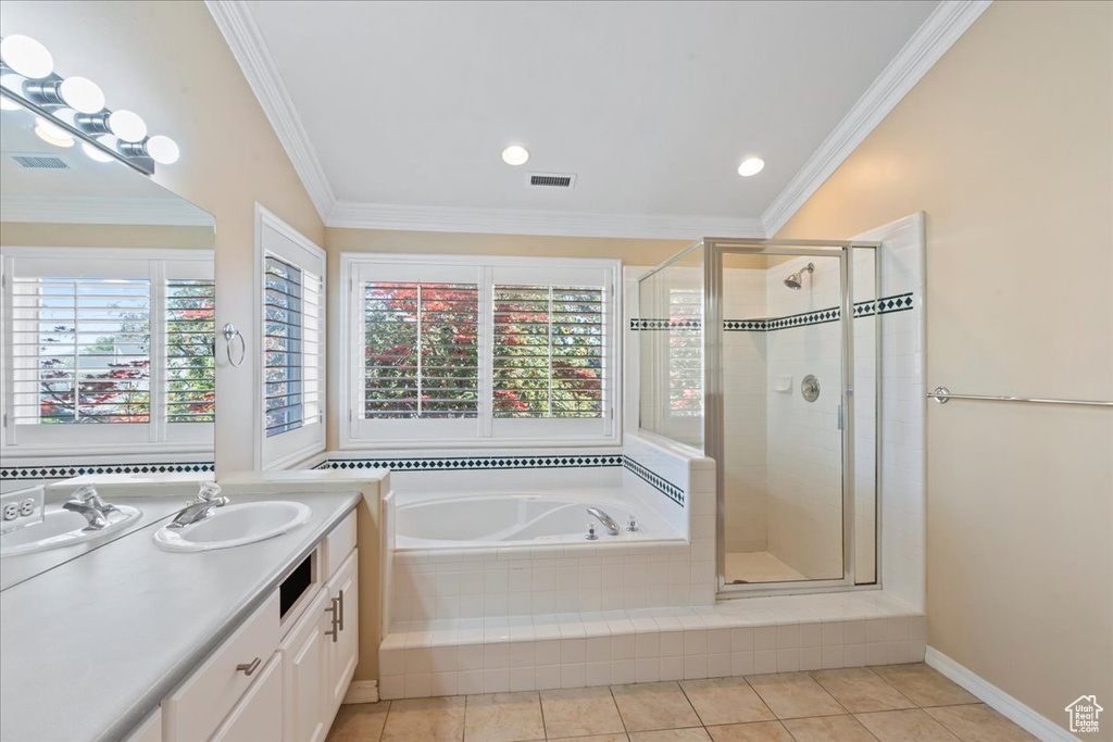 Full bathroom with a garden tub, vanity, a stall shower, crown molding, and tile patterned flooring