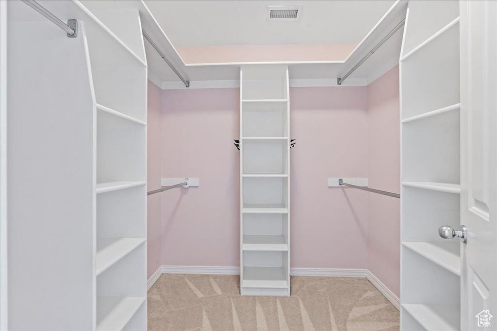 Spacious closet featuring carpet flooring