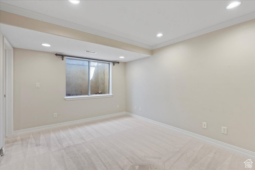 Carpeted empty room with recessed lighting and crown molding