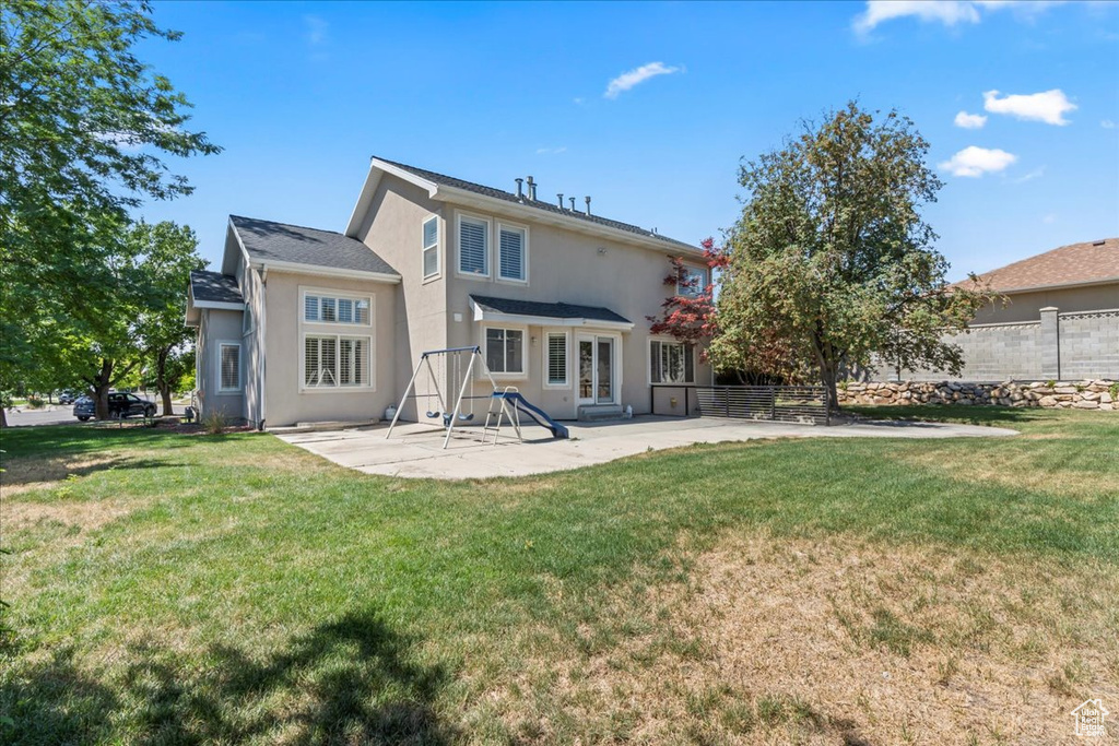 Rear view of property with a patio and stucco siding