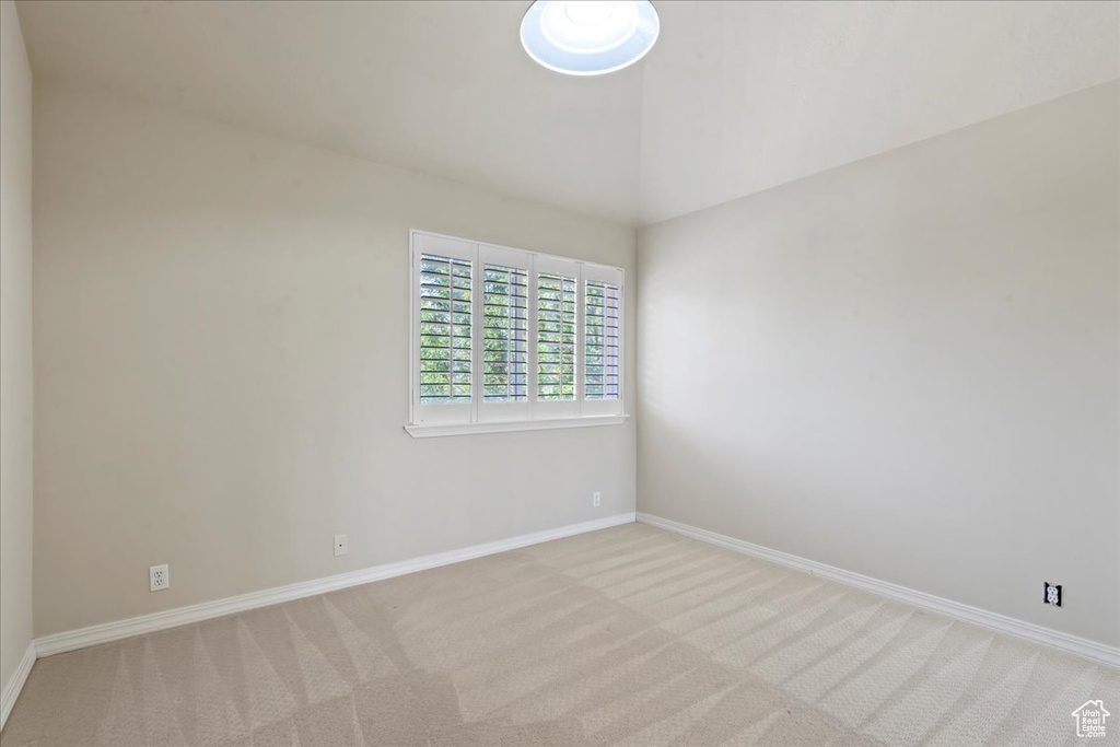 Carpeted spare room with baseboards