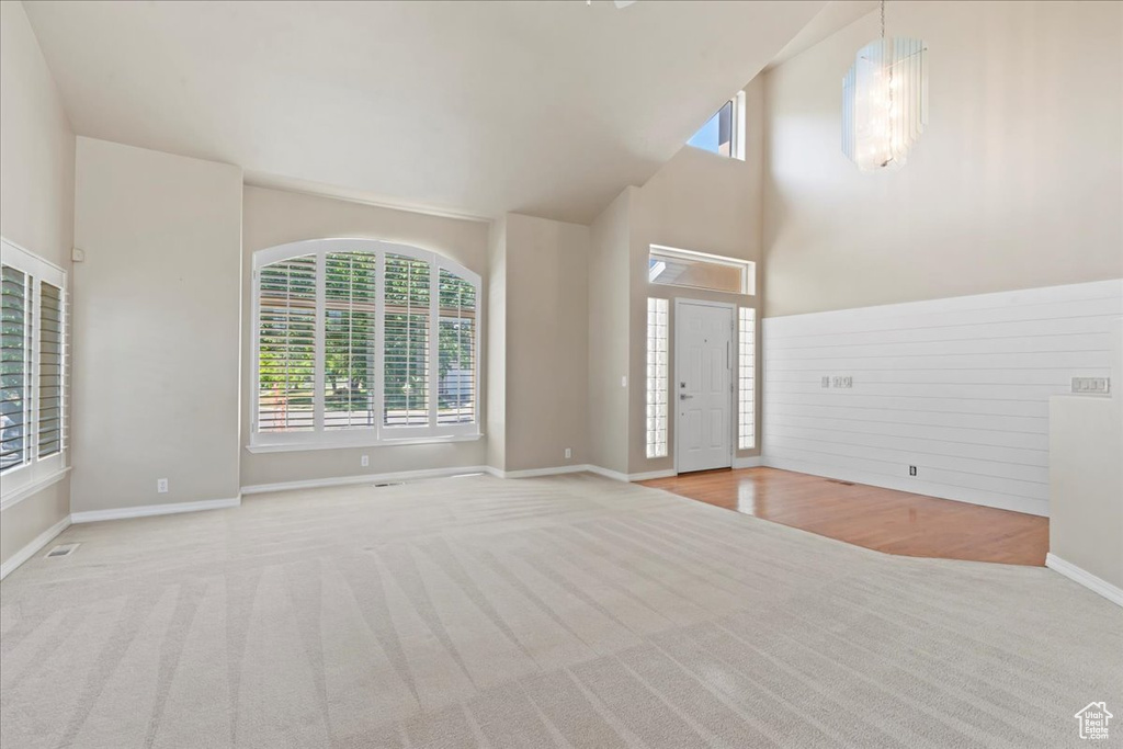 Foyer featuring carpet floors and a high ceiling