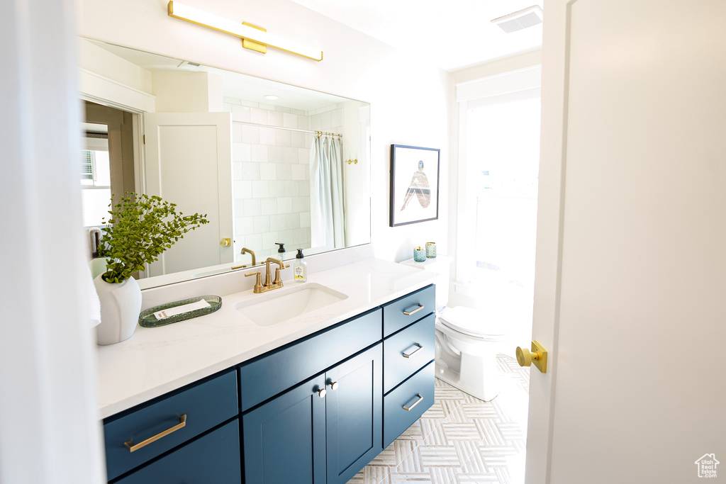 Bathroom with vanity and curtained shower