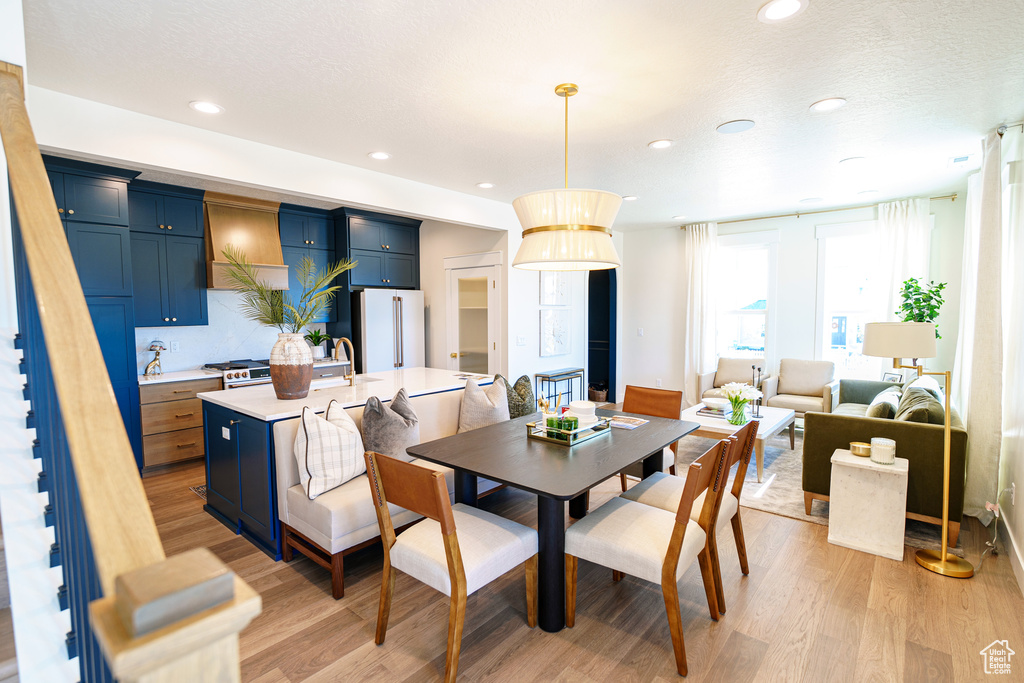 Dining space with light wood-type flooring and recessed lighting