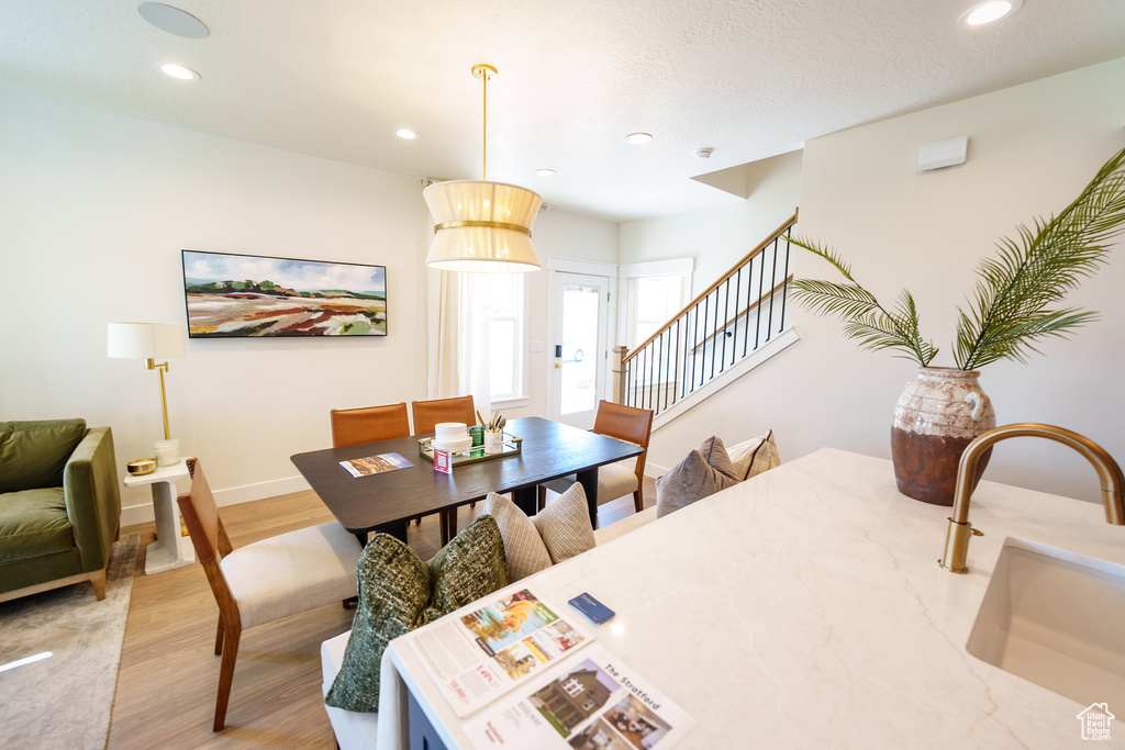 Dining space featuring stairs, light wood-style flooring, and recessed lighting