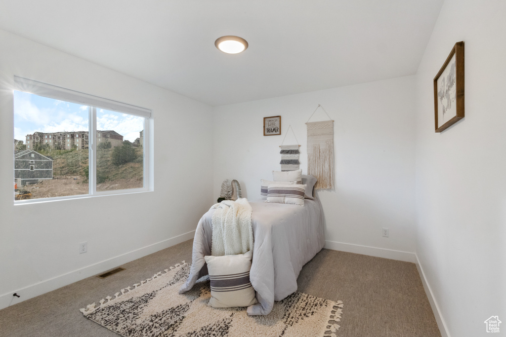 Carpeted bedroom with baseboards
