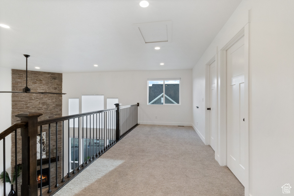 Corridor with carpet flooring and recessed lighting