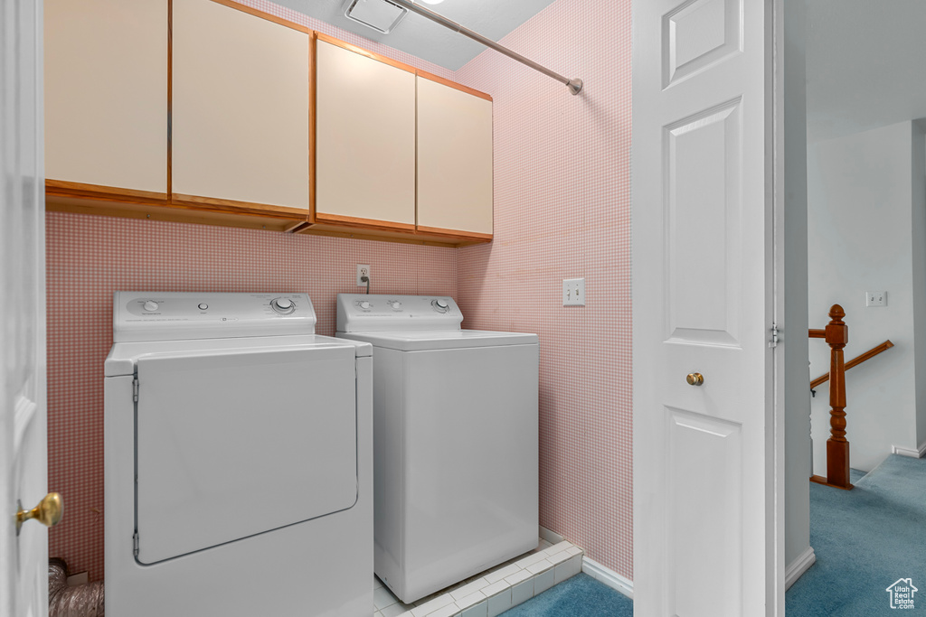 Laundry room featuring cabinet space and separate washer and dryer