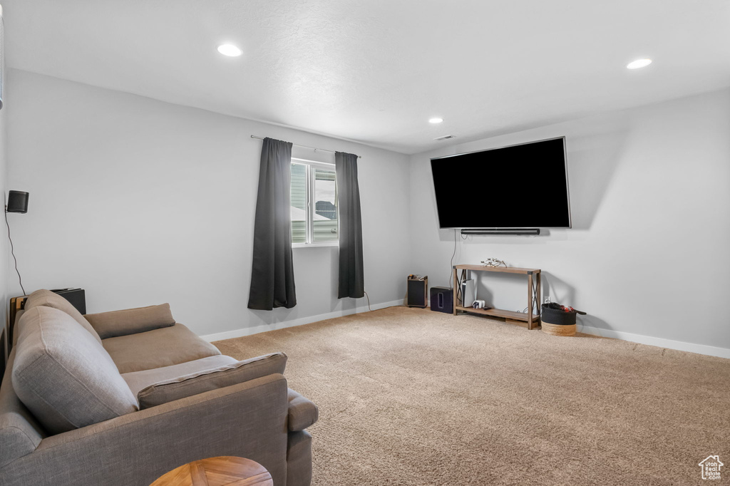 Carpeted living area featuring recessed lighting