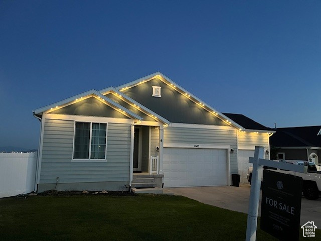 View of front of house with an attached garage and driveway