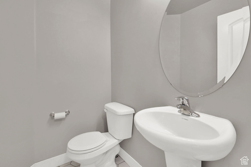 Bathroom featuring toilet and tile patterned flooring