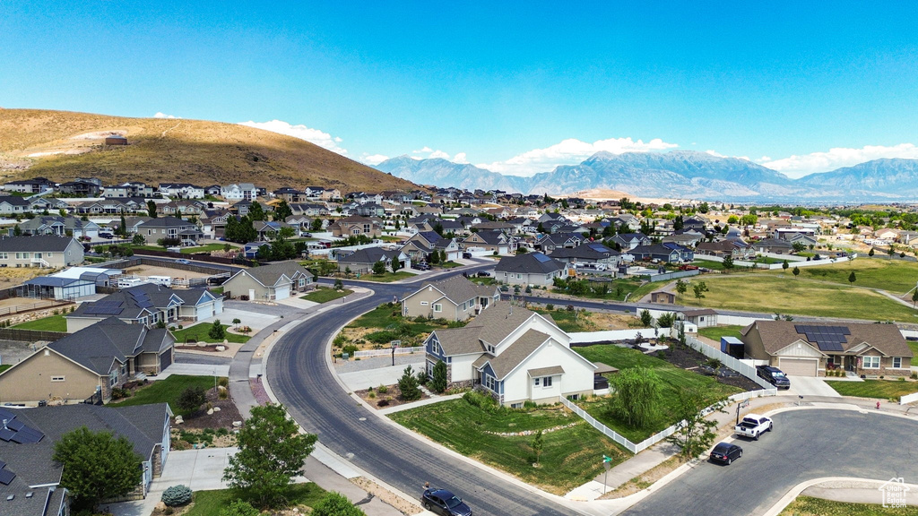 Aerial view of property's location featuring nearby suburban area and a mountain backdrop