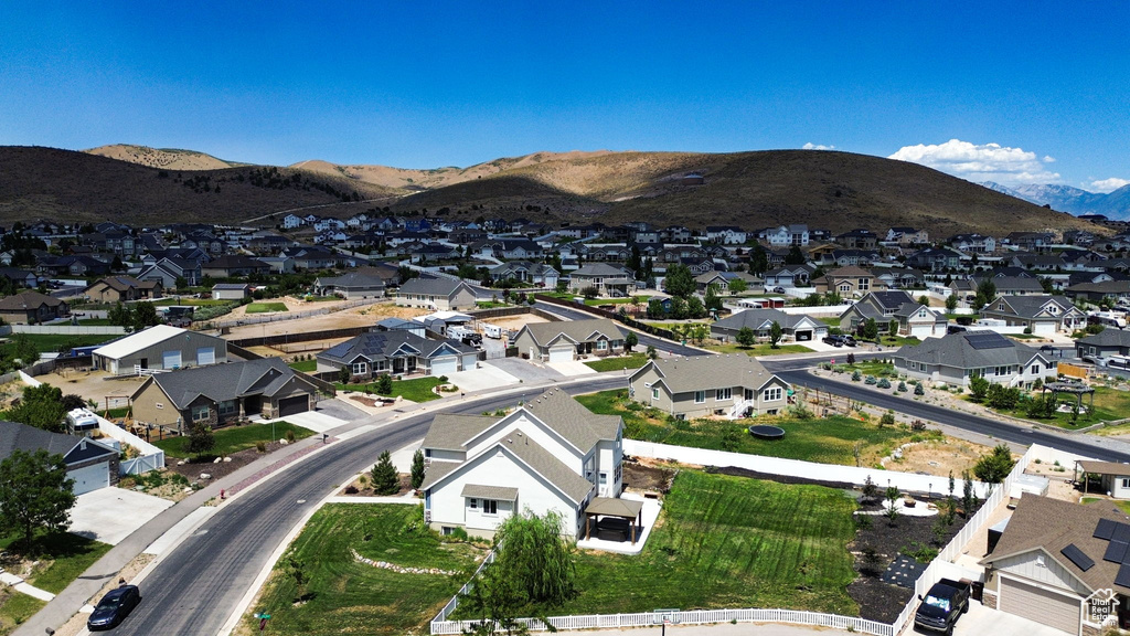 Aerial view of property's location with nearby suburban area and mountains