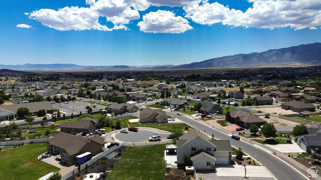 Aerial perspective of suburban area featuring a mountain backdrop