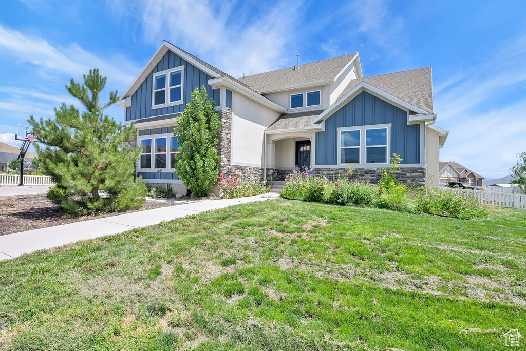 Craftsman house with stone siding, board and batten siding, and a shingled roof