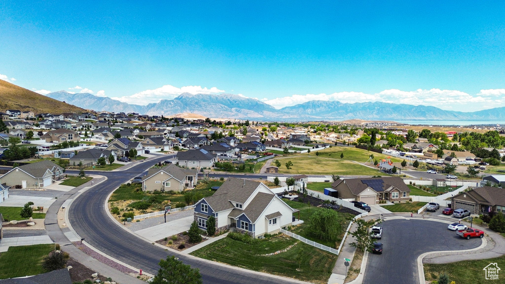 Aerial overview of property's location featuring nearby suburban area and a mountainous background