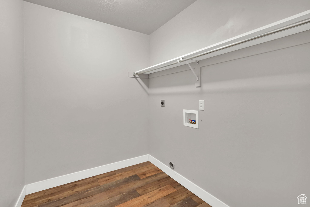 Washroom with dark wood-style floors, washer hookup, and electric dryer hookup