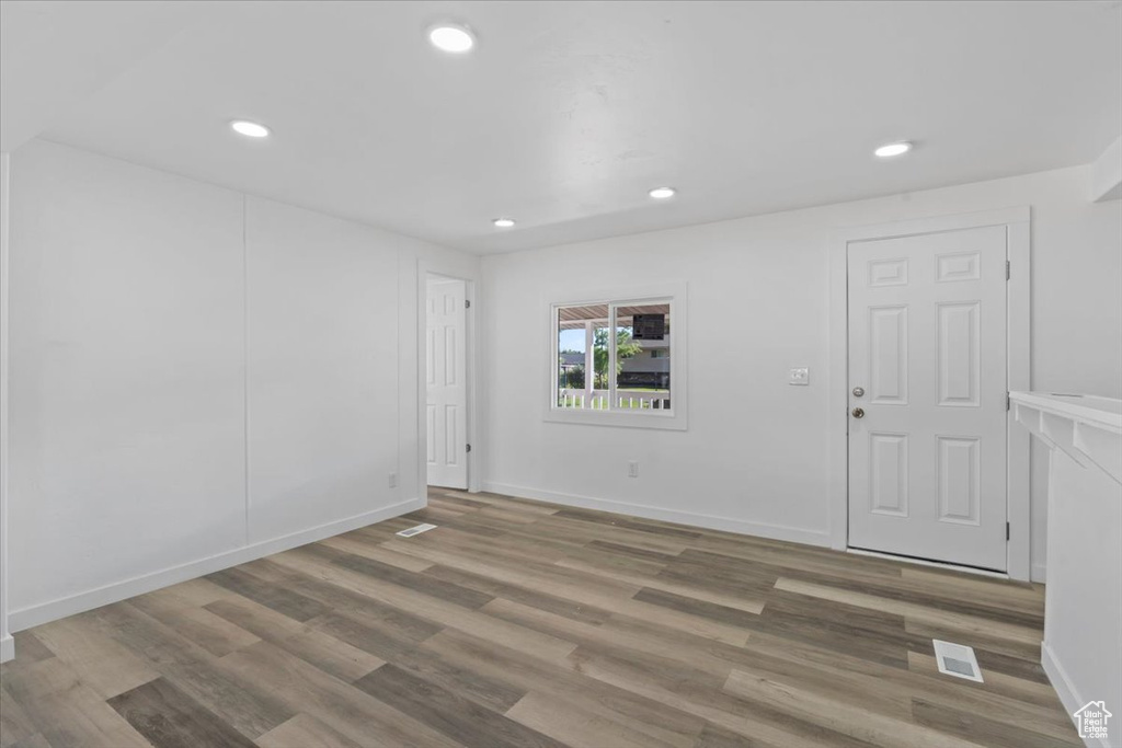 Unfurnished room featuring wood finished floors and recessed lighting