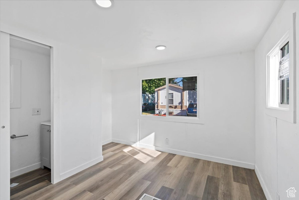 Empty room with wood finished floors and recessed lighting