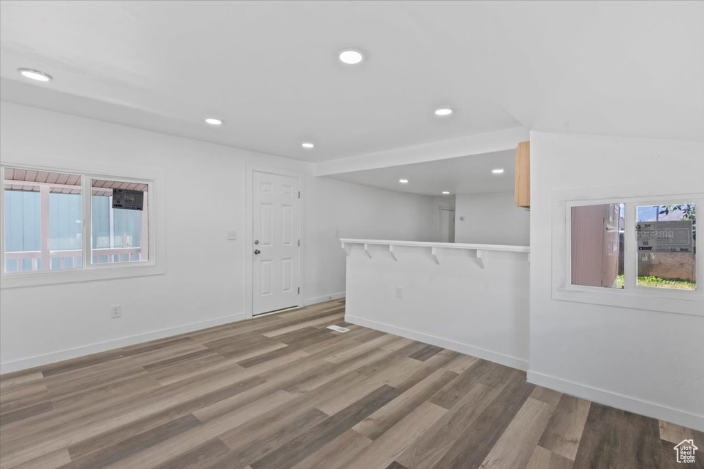 Unfurnished room with plenty of natural light, light wood finished floors, and recessed lighting
