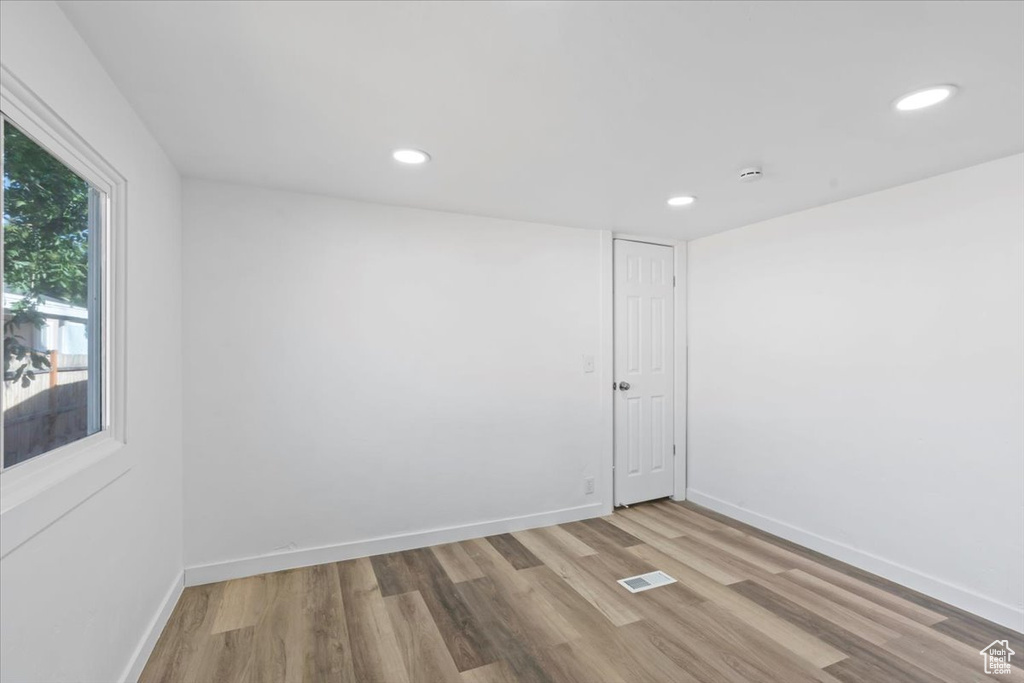 Spare room with wood finished floors, recessed lighting, and a smoke detector