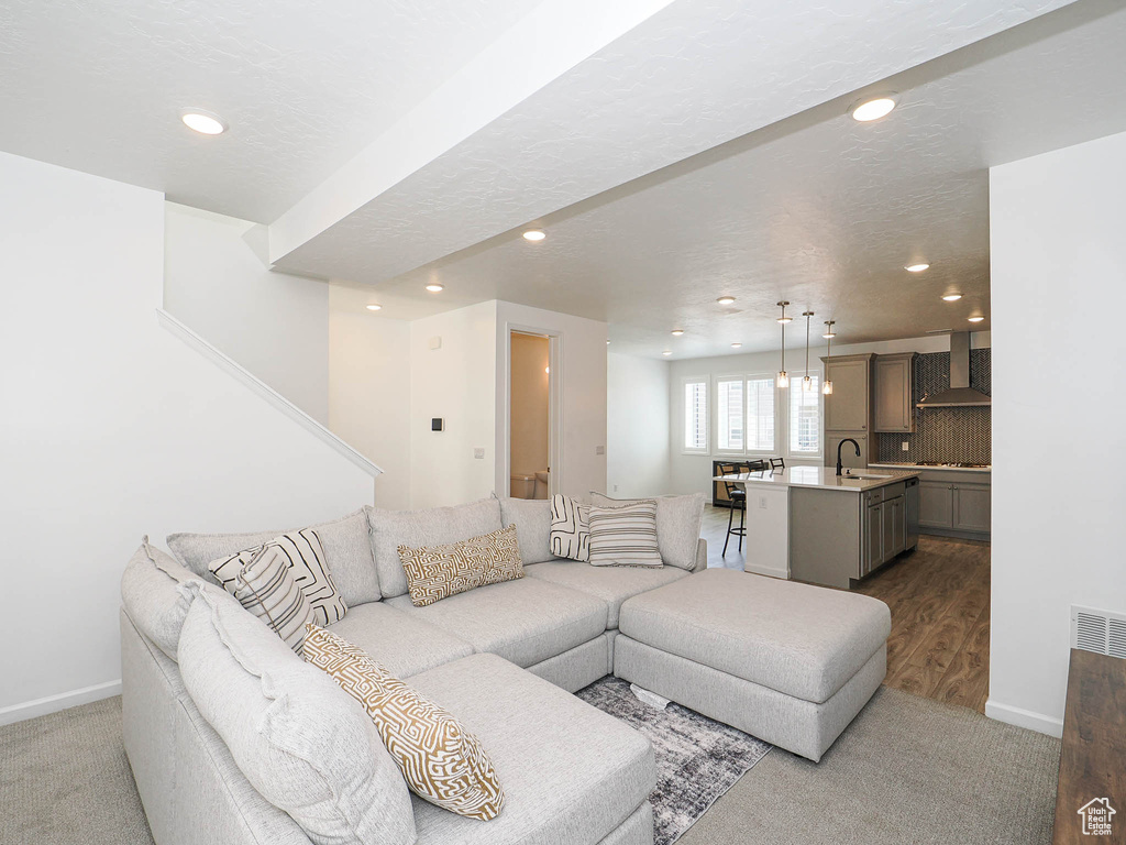 Living room with recessed lighting and dark carpet
