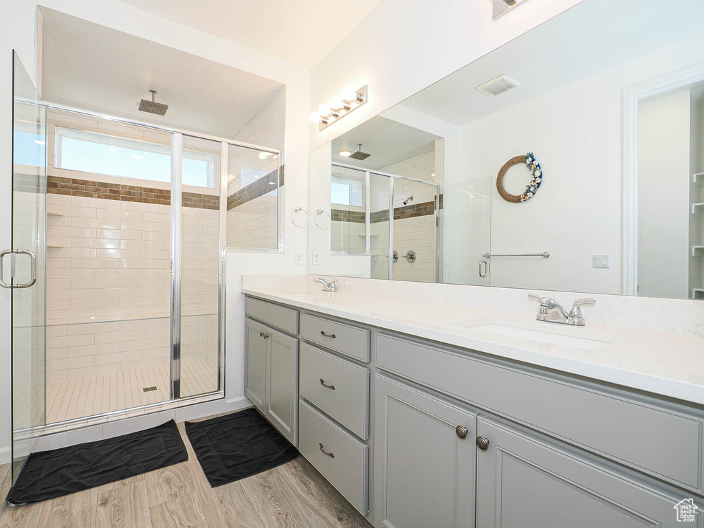 Bathroom with double vanity and a shower stall