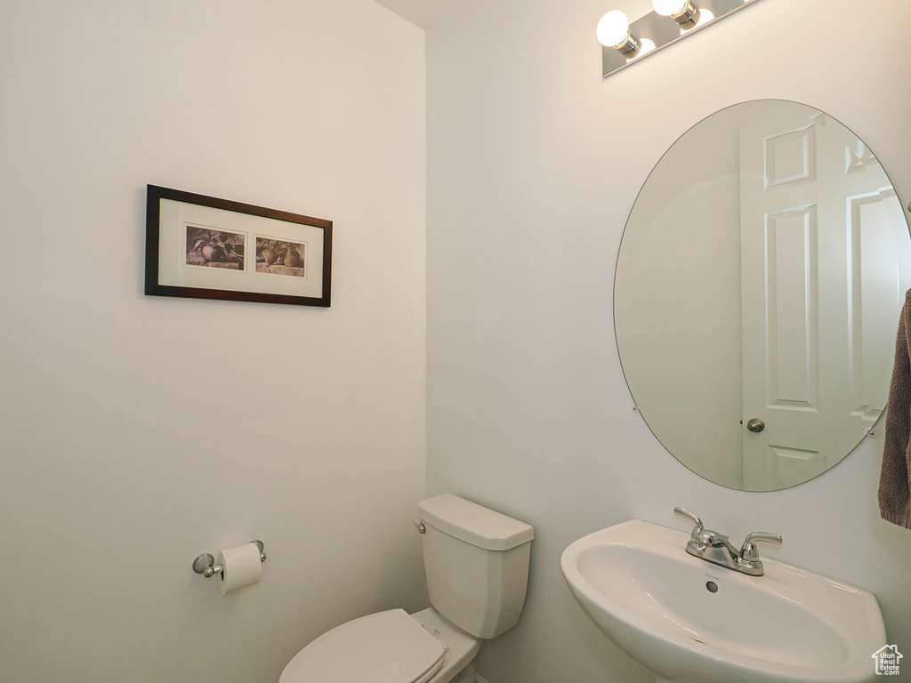 Half bathroom with a sink and toilet