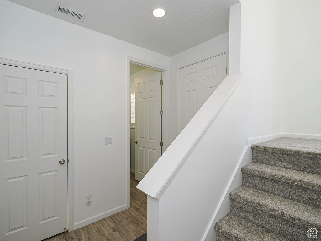 Stairway featuring wood finished floors and baseboards