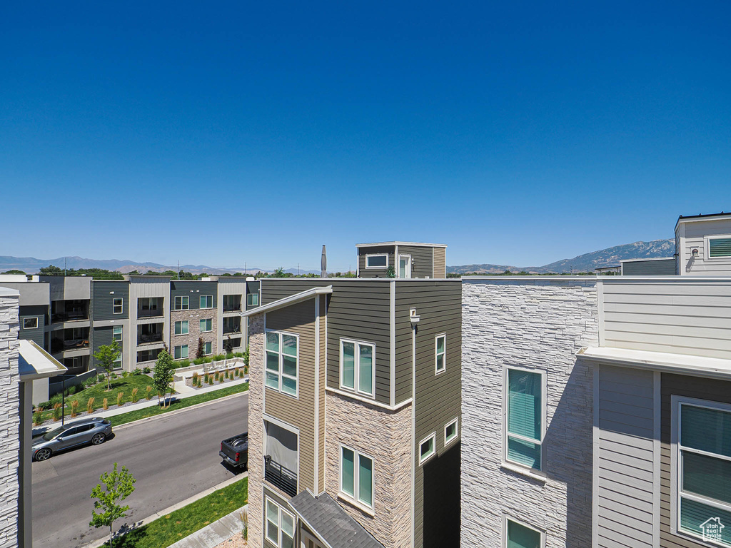 View of property with a mountain view and an attached garage