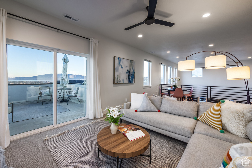 Living room featuring a ceiling fan, recessed lighting, carpet, and a mountain view