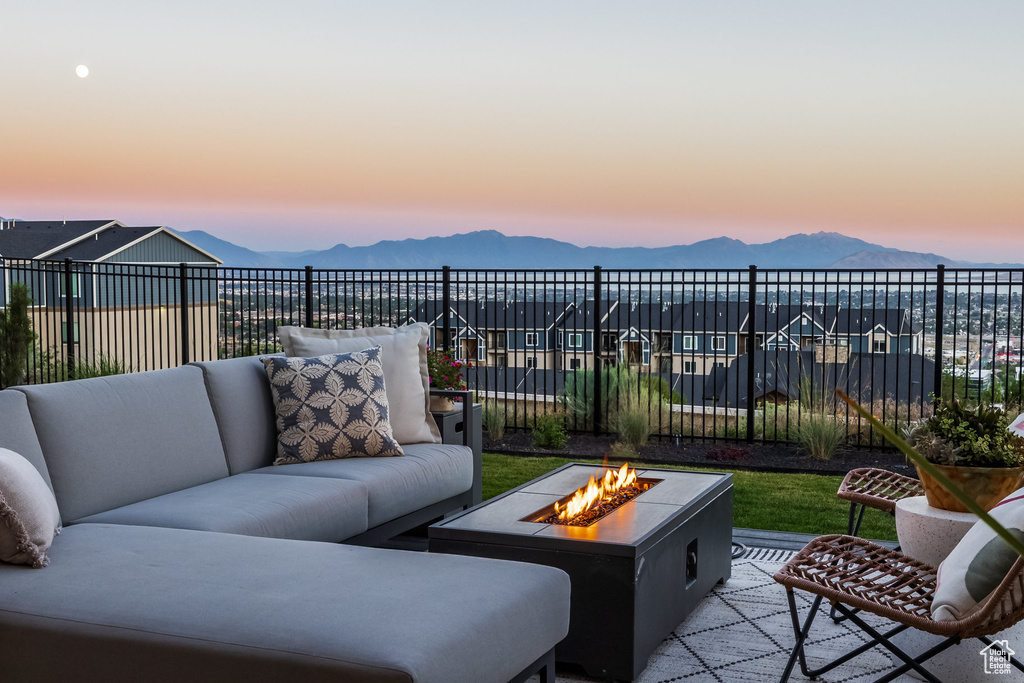 View of patio / terrace featuring a mountain view and an outdoor living space with a fire pit