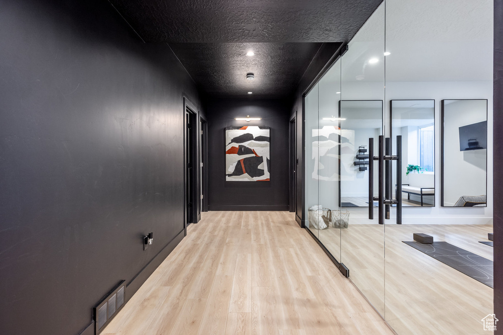 Hallway with light wood-type flooring