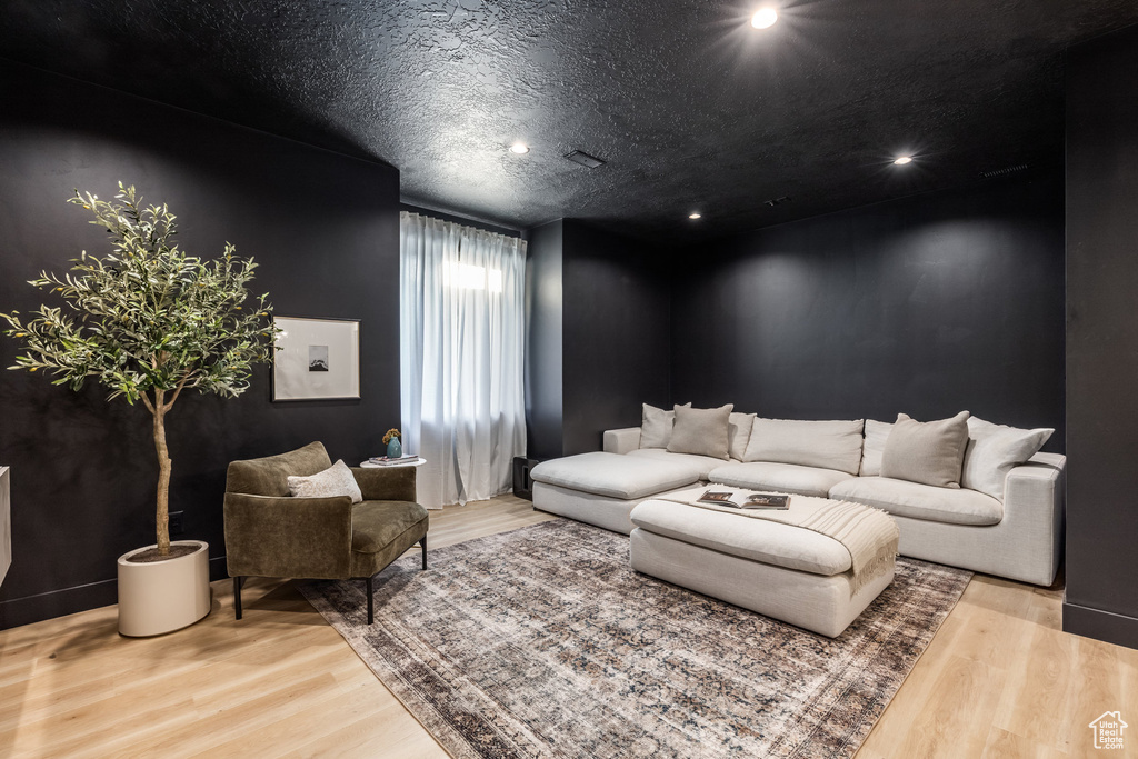 Living room featuring wood finished floors and recessed lighting