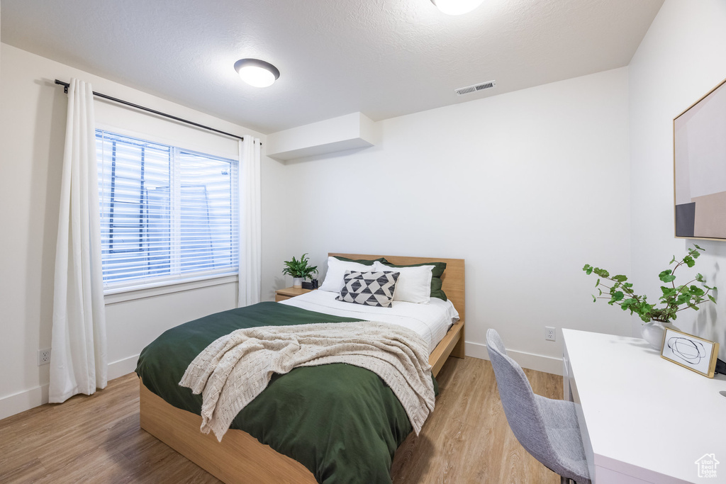 Bedroom featuring light wood-type flooring and baseboards