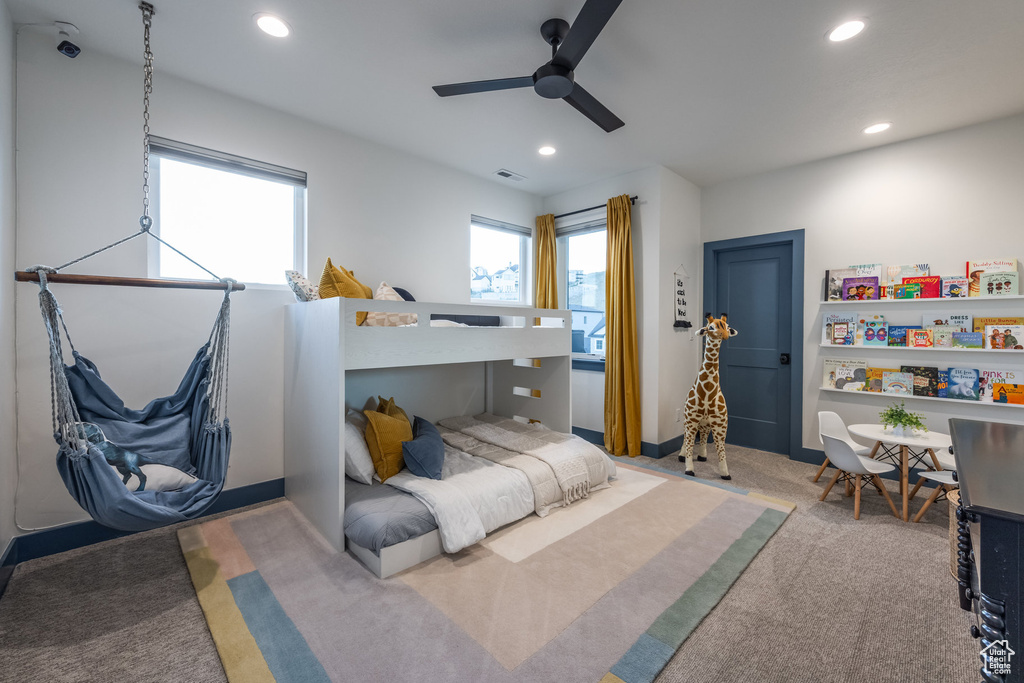 Carpeted bedroom with recessed lighting, multiple windows, and a ceiling fan