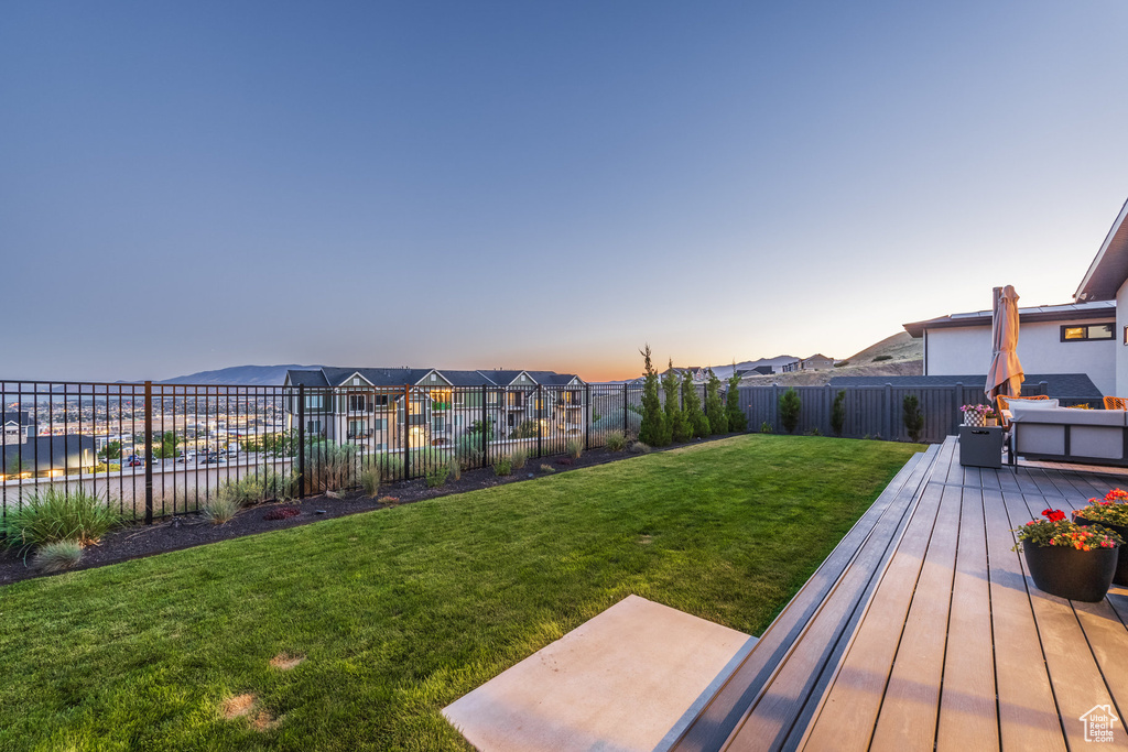 Yard at dusk featuring a fenced backyard