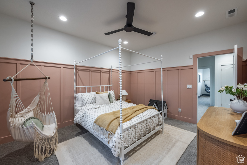 Bedroom with a decorative wall, carpet floors, a wainscoted wall, recessed lighting, and a ceiling fan