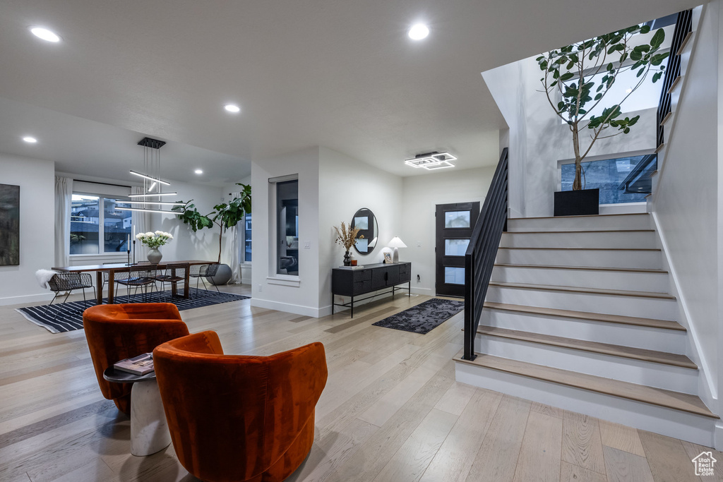 Entrance foyer featuring stairway, wood finished floors, recessed lighting, and a chandelier