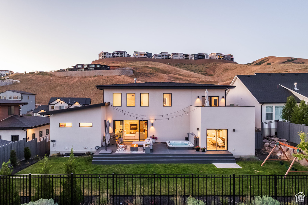 Back of house featuring an outdoor living space, stucco siding, and a fenced backyard