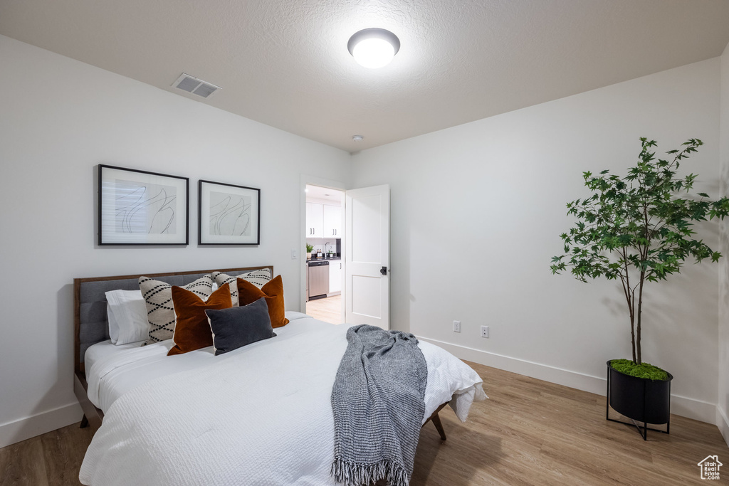 Bedroom with light wood-type flooring and baseboards