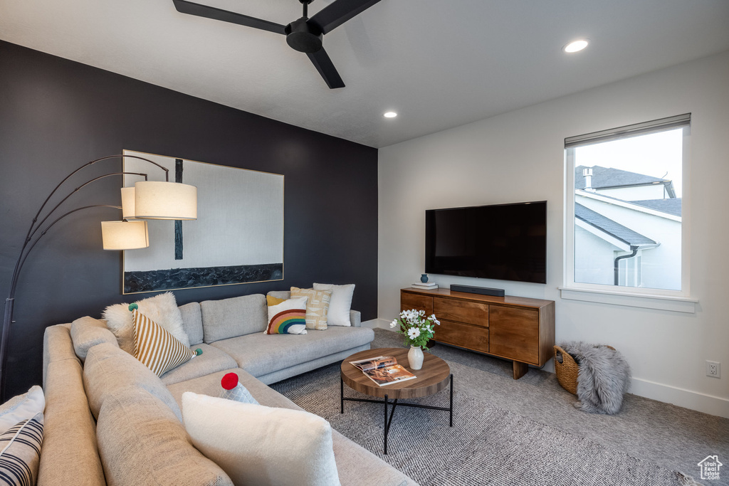 Living room featuring a ceiling fan, recessed lighting, and carpet floors
