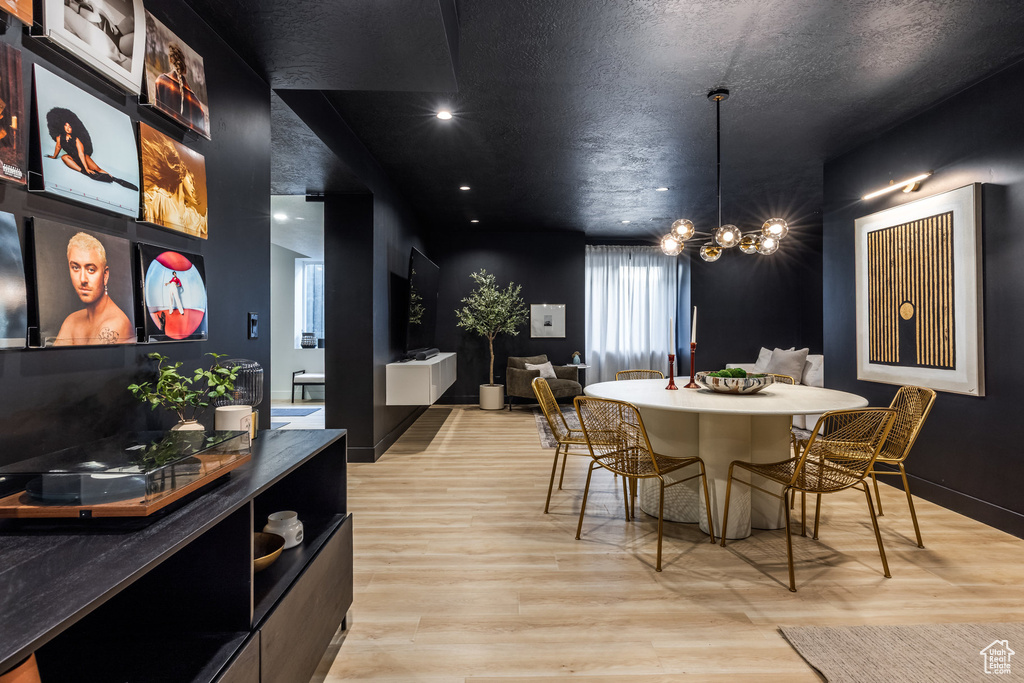 Dining area with a chandelier, light wood finished floors, and recessed lighting