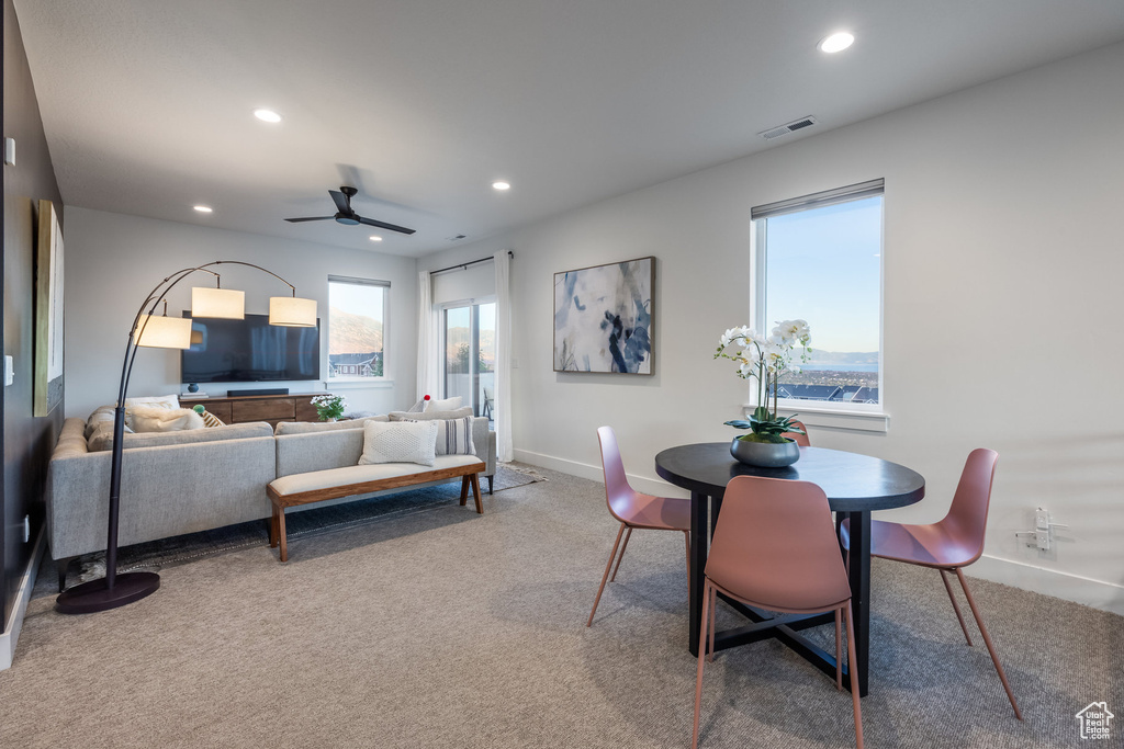 Dining area with carpet floors, ceiling fan, and recessed lighting