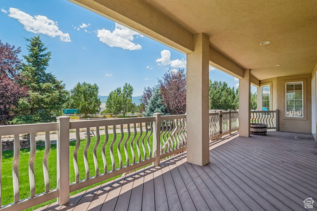 Wooden terrace featuring a lawn